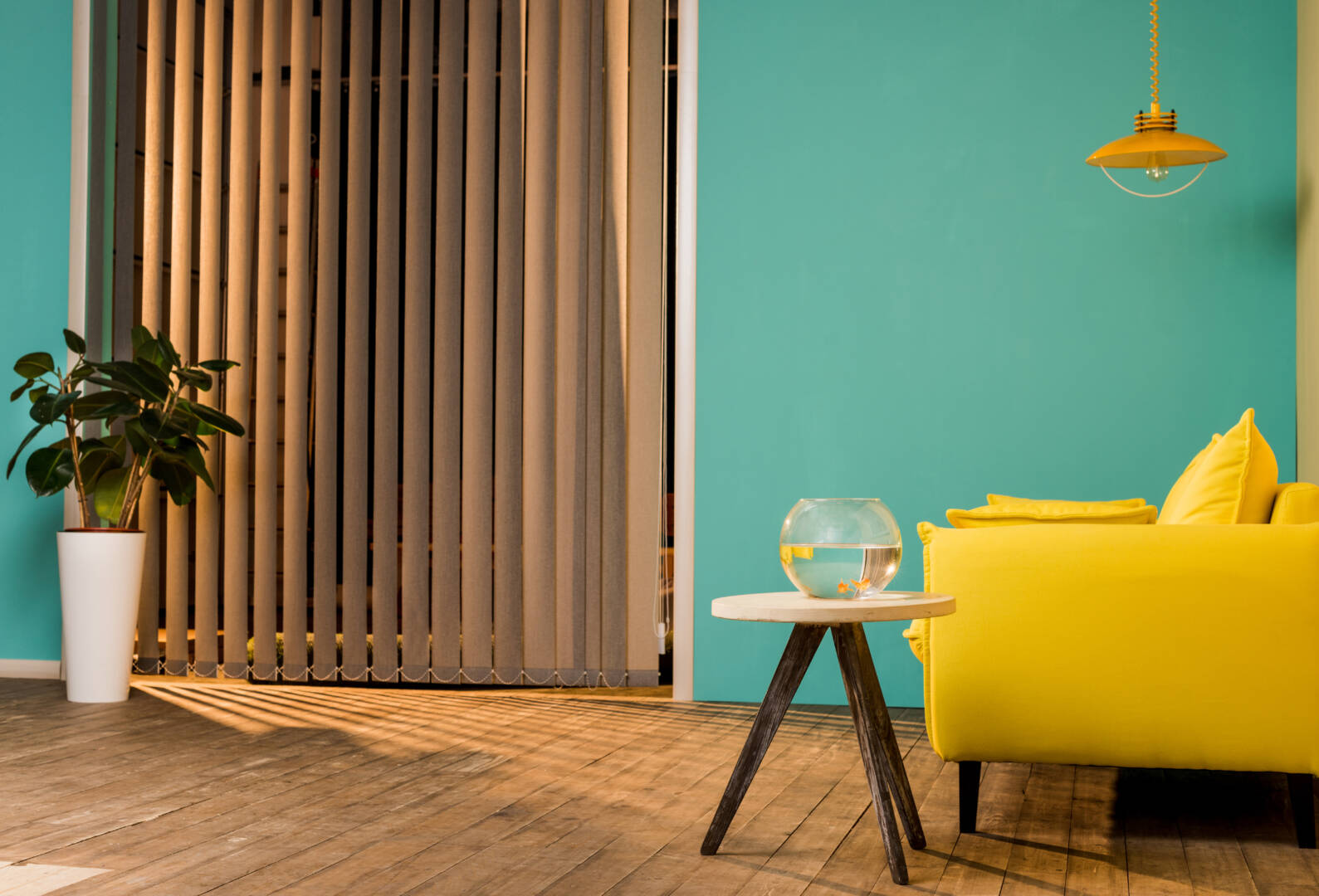 yellow sofa and aquarium with fish on table in living room